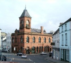 Arts Center Downpatrick. This Venetian Gothic red brick building replaced the old Market House in 1892. It was built at the sole expence of John Mulholland (the first Lord Dunleath). It was designed by William Butt of Belfast. The tall clock tower is a distinctive feature.Photo - Pat DevlinCLICK FOR LARGER PICTURE